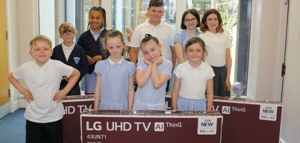 Children pictured with LG TVs that were donated to their school by Gleave and Amazon